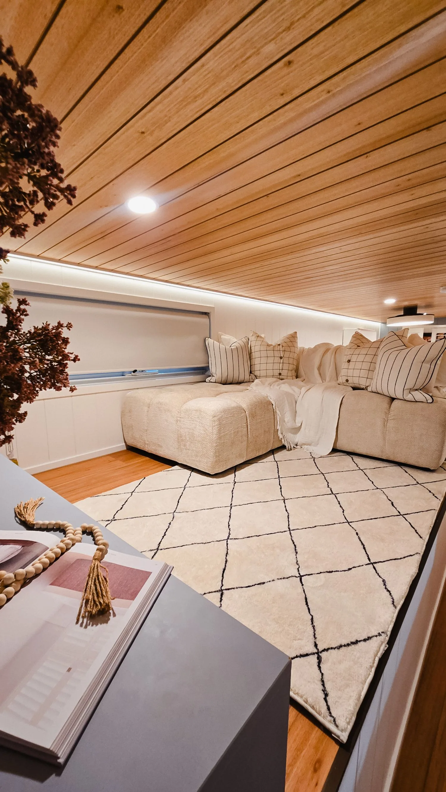 Serenity loft lounge with a cream modular sofa and patterned rug