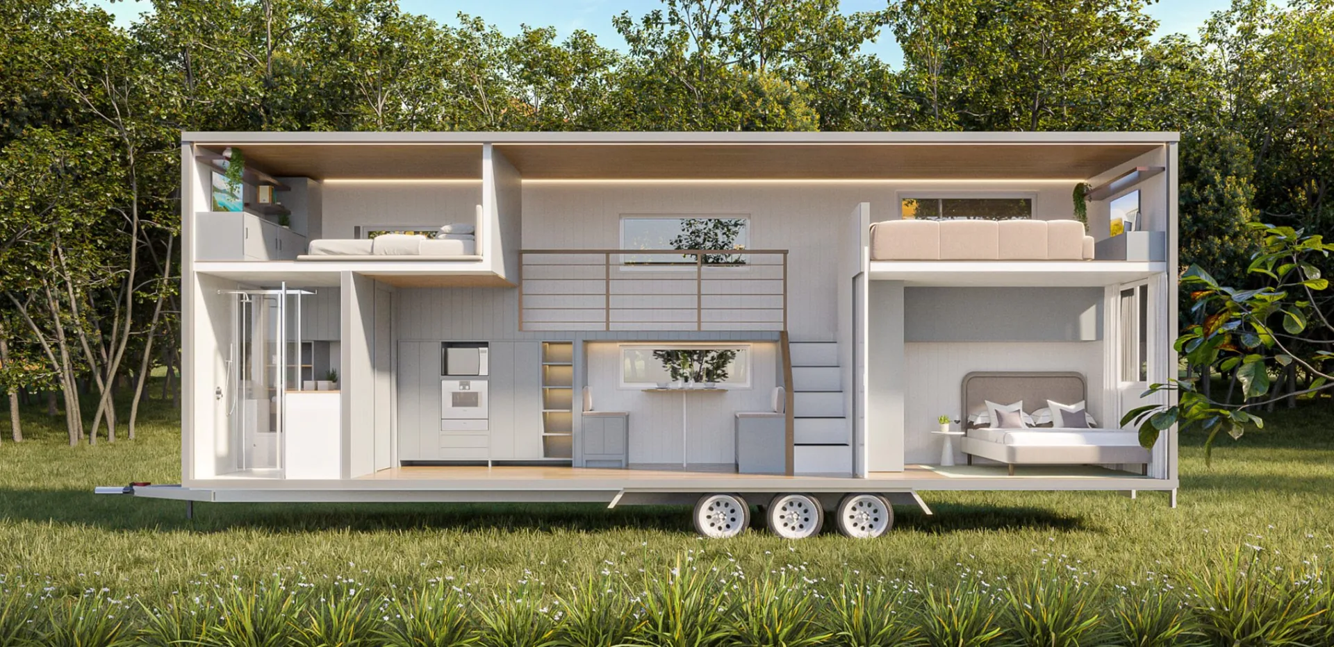 Cutaway of the Serenity showing the bathroom, kitchen, dining, bedrooms and loft, sited in a meadow
