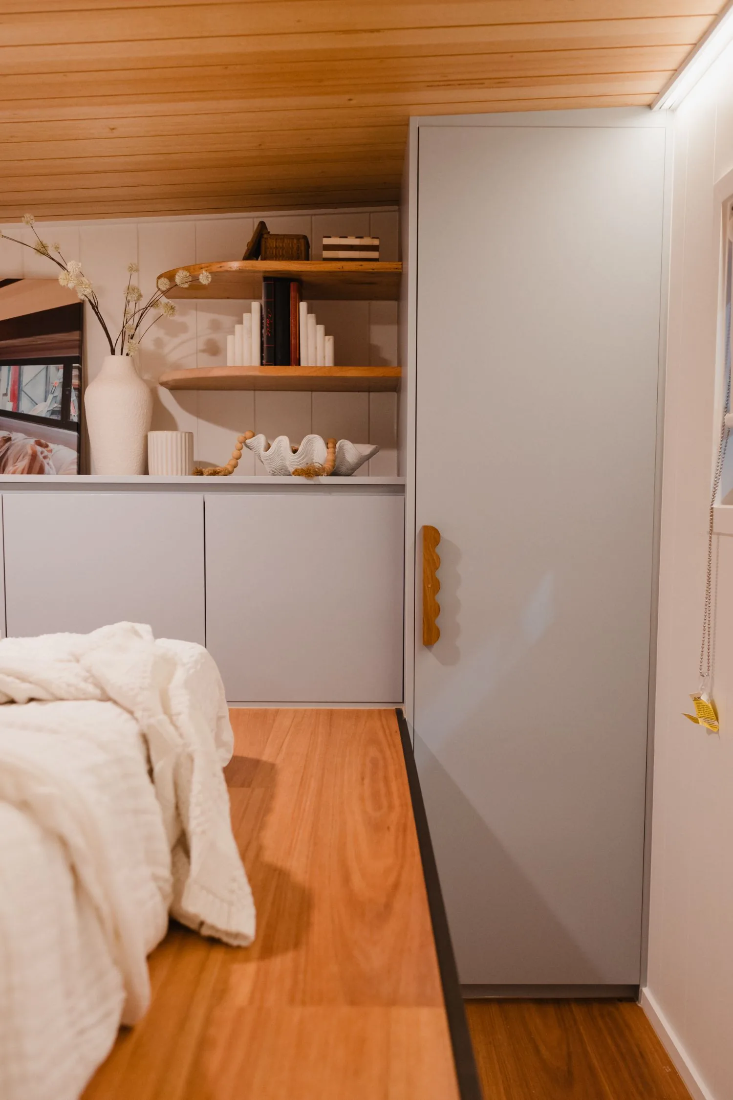 Serenity bedroom with full-height wardrobe and styled open shelving